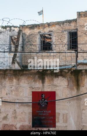 Ein türkischen militärischen Zeichen und eine griechische Flagge gelten an der Wand, die die Stadt von Nicosia, Zypern zu trennen. Nikosia der südlichen gliederte sich in griechisch-zyprischen und der türkisch-zyprischen Nordteilen 1963, nach der interkommunalen Gewalt, die in der Stadt ausbrach. Heute der nördliche Teil der Stadt ist die Hauptstadt von Nord-Zypern, ein de-facto-Staat, der als sein besetzt zyprischen Territoriums durch die internationale Gemeinschaft. © Simone Padovani / Erwachen Stockfoto