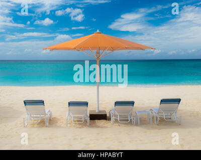 Sonnenschirm und Liegestühle am Seven Mile Beach in der Karibik, Grand Cayman, Cayman Islands Stockfoto