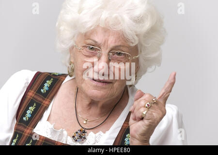 Model Release, Seniorin Mit Erhobenem Zeigefinger - ältere Frau mit erhobenen Zeigefinger Stockfoto