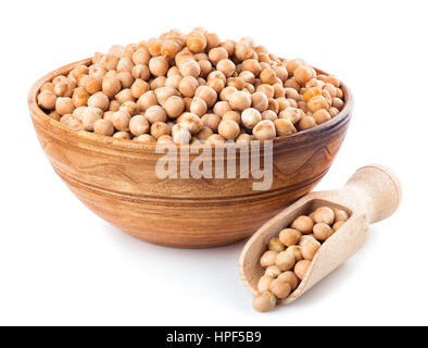 Trockene Kichererbsen in Ton Schüssel mit hölzernen Schaufel in der Nähe von isoliert auf weißem Hintergrund. Ungekochte Kichererbsen. Kichererbsen-Körner Stockfoto