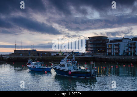 West Bay, Dorset, UK. 21. Februar 2017. Großbritannien Wetter. Aussehende Gewitterhimmel über West Bay Harbour in Dorset bei Sonnenuntergang nach einem Tag mit bedecktem Himmel und über Durchschnittstemperaturen. West Bay ist, dass die Einstellung für das ITV Serie Broadchurch getroffen, die am Montag, 27. Februar für Serie 3 zurückgibt. Bildnachweis: Graham Hunt/Alamy Live-Nachrichten Stockfoto