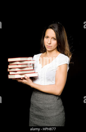 Junge Frau Mit Buchstapel - Frau mit Stapel Bücher, Modell veröffentlicht Stockfoto