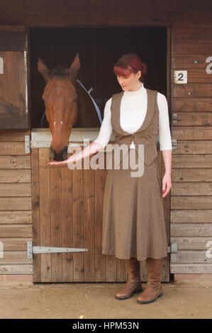 Schöne Frau in Wildhüter Tweed Anzug an einem stabilen Stockfoto