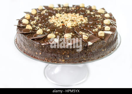 Lecker lecker Schokoladenkuchen mit Schokoladendekorationen und Walnüssen isoliert auf weißem Hintergrund Stockfoto