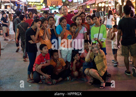 Eine Gruppe-Familie von asiatischen Touristen an der Pub Street, Siem Reap, wobei ein Selbstporträt mit einem Selfie Stick und Handy auf einer anstrengenden Nacht Straßenszene. Stockfoto