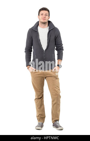Schön lässig Jüngling mit entpackten Pullover mit Händen in den Taschen. Ganzkörper-Länge-Porträt isoliert auf weißem Hintergrund. Stockfoto