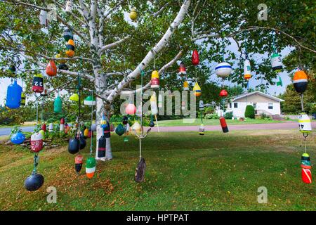 Bojen hängen als Dekoration in einem Baum in einem Garten an der Straße, Provinz Prince Edward Island, Kanada Stockfoto