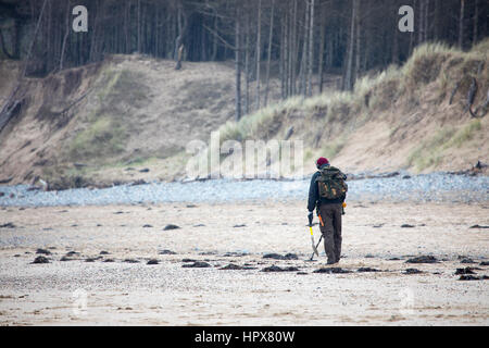 Mann Metalldetektoren an einem Sandstrand am Newborough, Anglesey Stockfoto