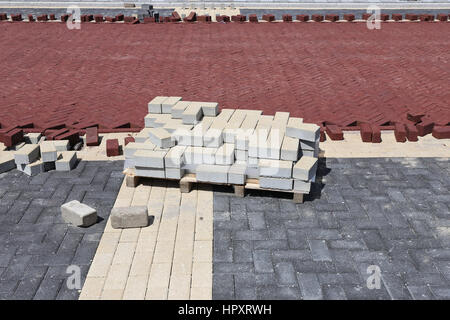 Palette mit Pflastersteinen auf Baustelle in Wohnzone Stockfoto