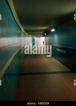 Männlich, die Eingabe eines beleuchteten Tunnel oder Unterführung Stockfoto