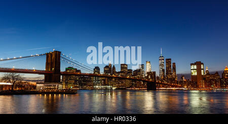 Eine Nachtaufnahme von einem beleuchteten Brooklyn Bridge mit einer Skyline von Manhattan Stockfoto