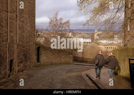 Edinburgh anzeigen die Hügel zwei Touristen zu Fuß auf der Straße die Stadt unter Stockfoto