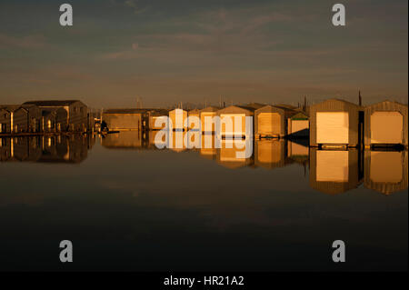 Bootshaus Reflexionen in Reihen entlang der Uferpromenade am Everett Marina mit mondaufgang. Stockfoto