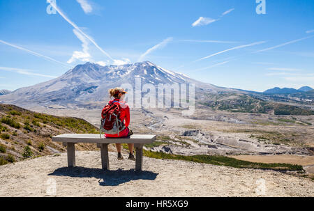 Eine Frau Wanderer Rast auf einer Bank auf dem Johnston Ridge Trail im Mount St. Helens National Volcanic Park, Washington, USA. Stockfoto