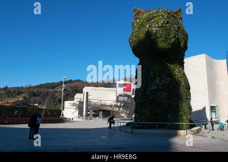 Spanien: die Blume Skulptur Puppy, gegründet 1992 von Jeff Koons am Eingang des Guggenheim Museum Bilbao und Blick auf die Skyline der Stadt Stockfoto