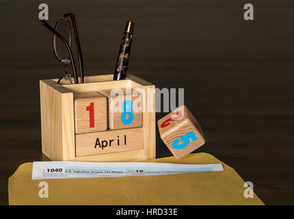 Holzbuchstaben in Kalender mit Formular 1040 Einkommensteuer für 2016 zeigt Steuer-Tag für die Einreichung ist anstelle der normalen 15. 18. April 2017. Nummer 5 ist show Stockfoto