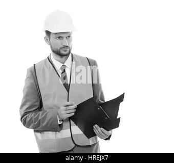 Unternehmer auf Arbeit. Monochrome Schuss von einem Geschäftsmann konstruktivistische tragen Helm und Warnweste posieren selbstbewusst mit seiner clipboa Stockfoto