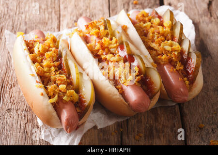 Dänische Speisen: Hot Dogs mit knusprigen Zwiebeln, Ketchup und sauren Gurken Nahaufnahme auf dem Tisch. horizontale Stockfoto