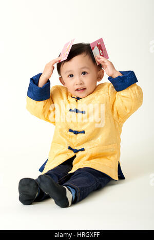 Chinesische Babyjungen in traditioneller Chinese New Year Outfit feiern Lunar New Year Stockfoto