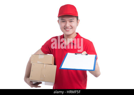 Hübscher junge Arbeiter im roten T-shirt und Cap lächelt, hält einen Ordner und Notizen auf weißem Hintergrund Stockfoto