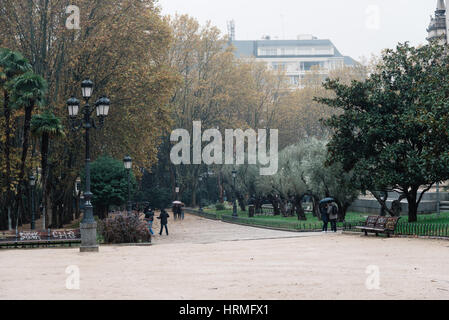 Madrid, Spanien - 20. November 2016: Regentag in Spanien Platz von Madrid. Menschen im Park spazieren Stockfoto