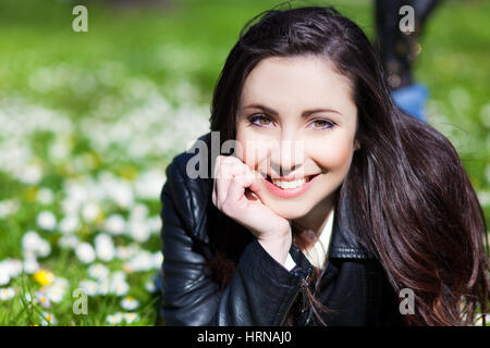 Schöne Frau im Gras liegend Stockfoto