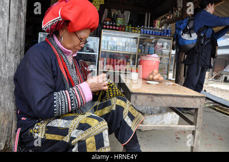 SAPA, VIETNAM - 24. Februar 2013: Unidentified Red Dao (Red Yao, Dzao) Frau im Dorf Ta Phin nähen. Sie sind chinesische Minderheit in Vietnam Stockfoto