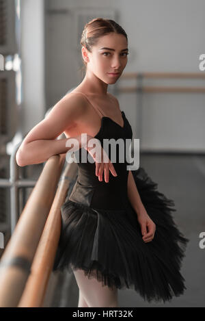 Weibliche Ballett-Tänzerin ruht in der Klasse mit Barre nach Probe Stockfoto