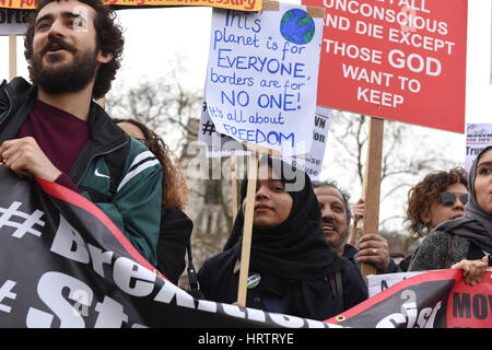 Ein junger Muslim Student Demonstrant hält ein Plakat lesen: "dieser Planet ist für alle, die Grenzen sind für niemand! Es geht um Freiheit Stockfoto