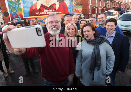 Michelle O'Neill, Führer der Sinn Féin in Nordirland (Mitte) mit Sinn Fien Präsidenten Gerry Adams (links) nimmt eine Selfie außerhalb der Sinn Féin-Hauptsitz in Belfast. Stockfoto