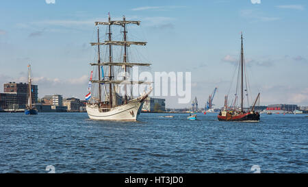 Amsterdam, Niederlande, 10. April 2016: Schiffe auf dem Fluss IJ hinter dem Hauptbahnhof von Amsterdam. Stockfoto