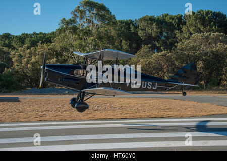Seitenansicht von einem DH Fox Moth Doppeldecker abheben von der Startbahn Stockfoto