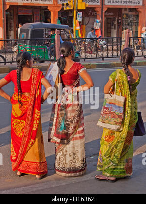 Frauen in der Regel buntes Kleid warten für den Verkehr im Zentrum von Jaipur, Indien Stockfoto