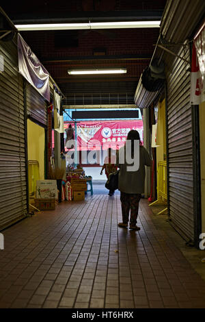 Honolulu; Hawaii; USA - August 6; 2016: ein Kunde geht an Kreditor Stände in einer dunklen Gasse im Chinatown Historic District; eine populäre lokale desti Stockfoto