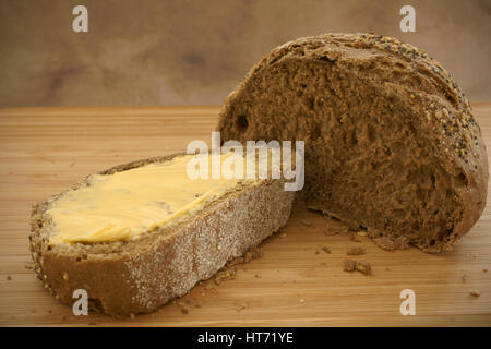 Gebuttertes Schwarzbrot in natürlichem Licht Stockfoto