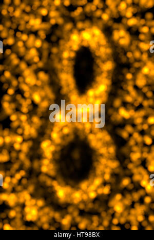 abstrakt und festliche gold Bokeh Hintergrund, unscharfen Lichter in Form von 8. Dekorative Gruß Postkarte für internationaler Frauentag. Stockfoto