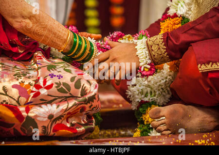 Eine Nahaufnahme von einer Braut und Bräutigam Hände berühren während einer Hindu-Hochzeitszeremonie. Stockfoto