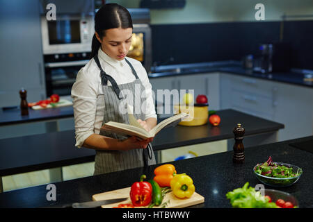 Hausfrau Rezept im Kochbuch lesen Stockfoto
