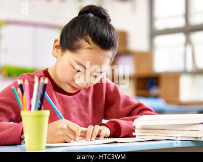 asiatische Grundschule Schüler lernen oder Hausaufgaben im Klassenzimmer. Stockfoto