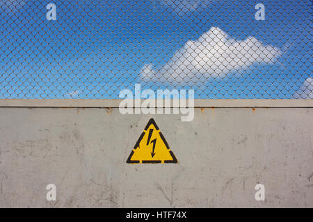 Obstruktion, unsichere markieren, Hochspannung und Raster. Gefahr des Todes. Der Himmel hinter dem Zaun Stockfoto