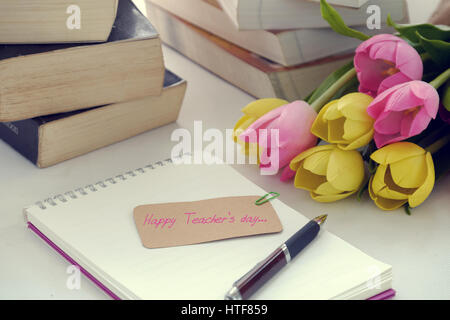 Glückliche Lehrer Tag, handgefertigte Tulpe Blumentopf, bücherstapel, Nachricht für Lehrer in besonderen Tag der Bildung, Tulip Bouquet aus Tonmaterial diy Stockfoto