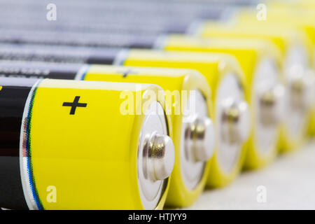 Nahaufnahme einer Diagonale Zeile gelb schwarz AAA alkaline Batterien isoliert auf weißem Hintergrund Stockfoto