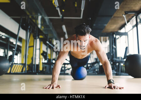 Sportlicher Athlet doing Push-Ups im Fitness-Studio während des Trainings Stockfoto