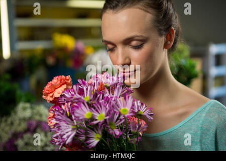 Frau einen Blumenstrauß im Blumenladen riechen Stockfoto