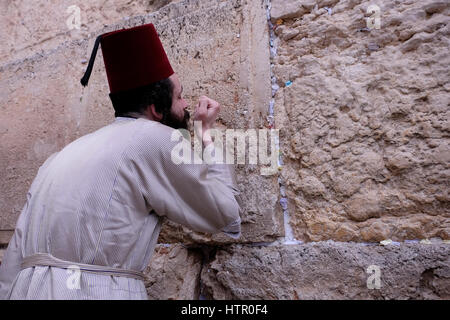 Ein Ultra orthodoxer Jude tragen eine traditionelle muslimische Tarbusch oder Fez Hut Kostüm beten während des jüdischen Festivals von Purim in der Klagemauer oder Kotel in der Altstadt Ost-Jerusalem Israel Stockfoto