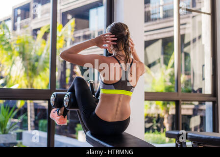 Attraktive Fit Frau Arbeit aus abs im Fitness-Studio im Luxus Resorthotel mit einem tollen Blick in den Sommerferien Stockfoto