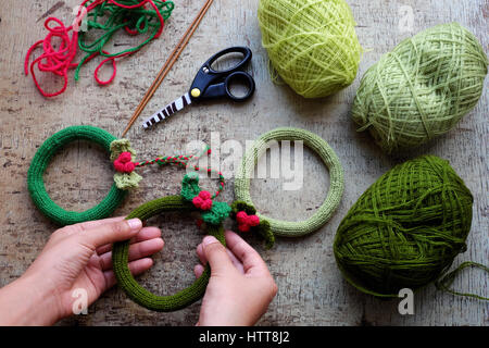 DIY-Adventskranz für die Dekoration die Tür auf Weihnachtsurlaub, eine traditionelle festliche im Winter, in Runde Kränze für Weihnachtsdekoration zu stricken Stockfoto