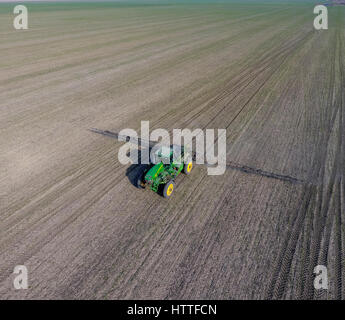 Traktor mit aufklappbaren Sprühen von Pestiziden. Düngung mit einem Traktor, in Form eines Aerosols auf dem Gebiet der Winterweizen Stockfoto