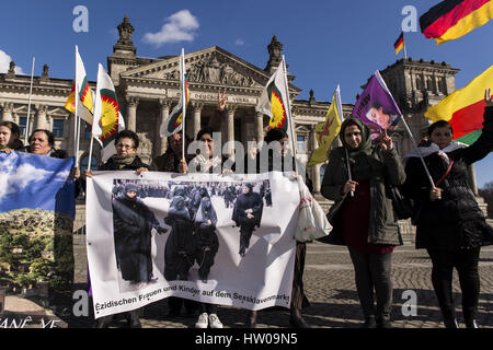 Berlin, Berlin, Deutschland. 15. März 2017. Jesidisch Vertreter und Kurden fordern politische Unterstützung vor dem Deutschen Reichstag-Gebäude für die Menschen in Sindschar. Die Lage des Yezidians, eine tausendjährige monotheistischen Religionsgemeinschaft, verschlechtert sich nach kurdischen Peschmergas der kurdischen Yezidian Einheiten im Sinjar angegriffen. Demonstranten halten die Fahnen mit dem Bild von ABDULLAH Ã – CALAN und das Zeichen der kurdischen Miliz YPG, die das Bundesministerium des Innern (BMI) zu Beginn des März 2017 zusammen mit anderen Symbolen verboten im Zusammenhang mit der PKK. Die Polizei habe nicht inte Stockfoto