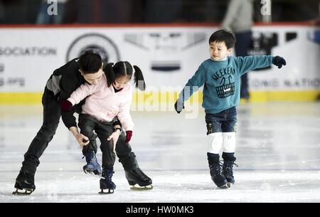 (170323) - HONG KONG, 23. März 2017 (Xinhua)--Kinder lernen Skaten von einem Coach in Mega-Eisbahn in Hongkong, Südchina, 1. März 2017. Hong Kong hat bisher 5 Eisbahnen. Diese Eisbahnen befinden sich alle in den großen Einkaufszentren, mehr Bürger kommen zu gewinnen. Hong Kongs Home Affairs Bureau, Freizeit und Cultural Services Department, sowie Hong Kong Ice Hockey Association haben gesponserten Wintersport und internationalen Winterspiele und arrangiert Trainer um Wintersport in mehr als 200 Schulen in Hong Kong zu fördern. Hong Kong Academy von Eishockey, die im Jahr 2007 gegründet wurde, eine Stockfoto